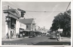 Brooksville, Florida Street Scene with Vintage Cars and Businesses Postcard