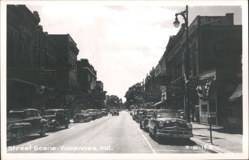 Downtown Street Scene with Vintage Cars and Businesses Vincennes Indiana