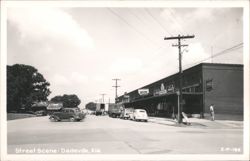 Street Scene with Vintage Cars and Storefronts Postcard
