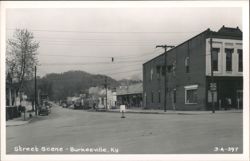 Street Scene with McCoy Motor Court and Bank Building Postcard
