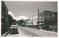 Street Scene with Vintage Cars and Storefronts Postcard