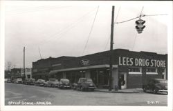 Street Scene at Lees Drug Store with Vintage Cars Postcard
