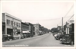 Street Scene with Vintage Cars and Storefronts Postcard