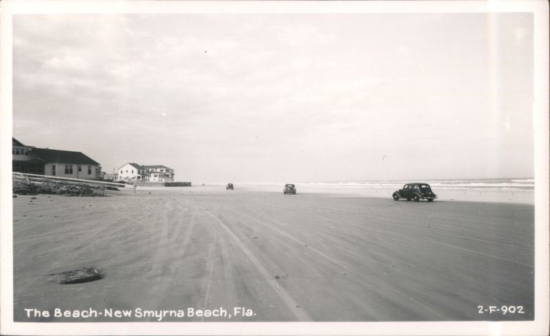 Cars on the beach with houses in the background New Smyrna Beach Florida