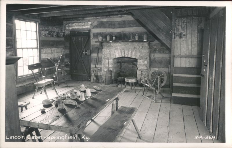 Lincoln Cabin interior with fireplace, spinning wheel, and rustic furniture Springfield Kentucky