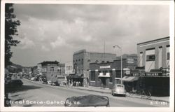 Street Scene with Gate City Theatre, Bush's Restaurant, and Local Businesses Postcard