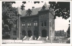 U.S. Post Office building with parked car and trees Postcard