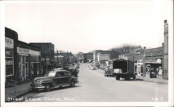 Downtown Street Scene with Shops and Cars Postcard