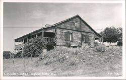 Lincoln Lodge log cabin building with porch and stairs on a hill Postcard
