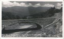 The Blue Ridge Parkway At Buck Creek Gap, Mt. Mitchell In The Distance Postcard