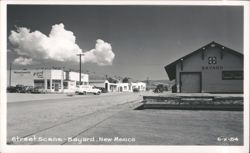 Street Scene with Businesses and Train Depot Postcard