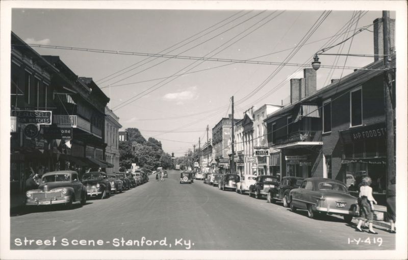 Main Street Scene with Shops, Vintage Cars, and Pedestrians Stanford Kentucky