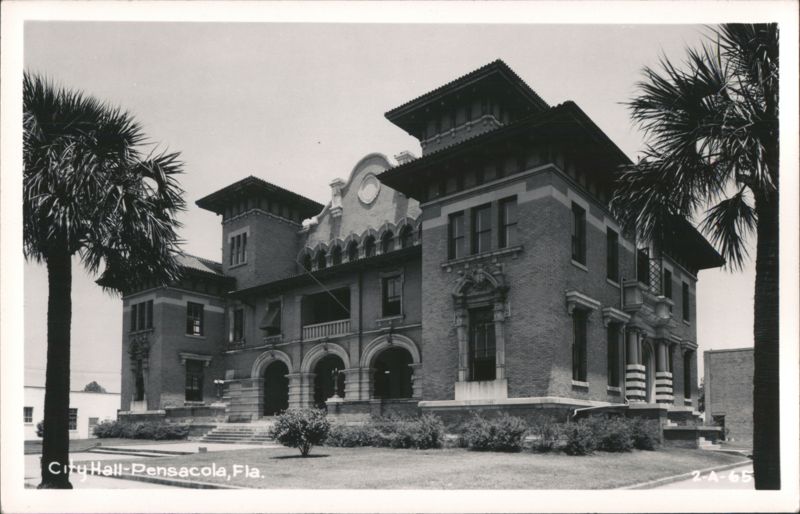 Ornate brick City Hall building with prominent palm trees Pensacola Florida