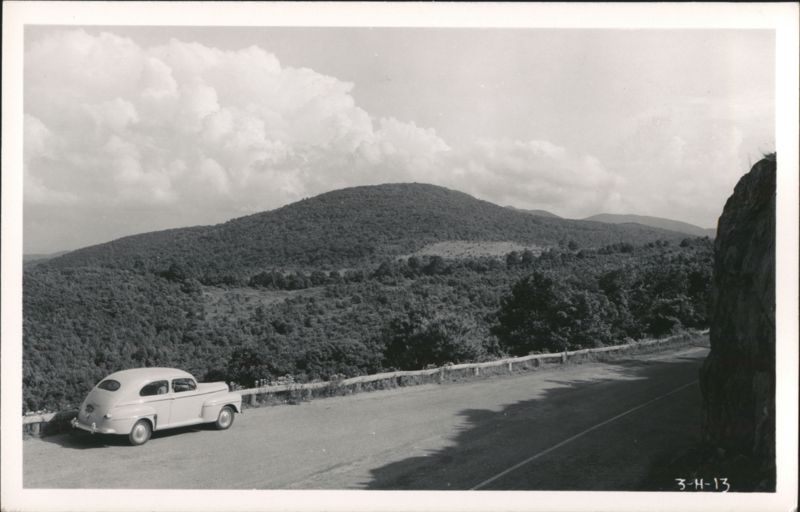 Car parked on mountain road with scenic view and cloudy sky Virginia