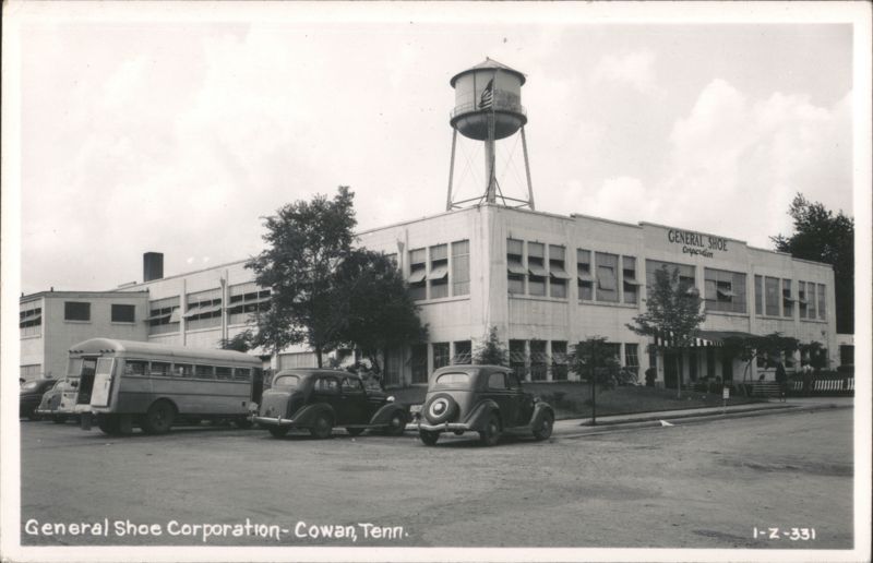 General Shoe Corporation building with water tower and vehicles Cowan Tennessee