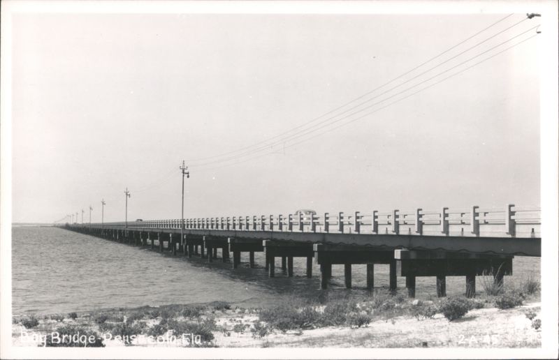 Bay Bridge over water with cars and power lines Pensacola Florida