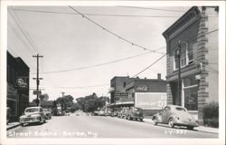 Downtown Street View with Storefronts and Automobiles Postcard