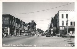 Downtown Street Scene with Shops, Vintage Cars, and Pedestrians Postcard