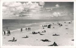 Pensacola Beach with Swimmers, Sunbathers, and a Vehicle on Sand Postcard