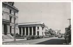 Busy street scene with classic cars and historic buildings, Pensacola Postcard