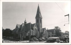 First Presbyterian Church with cars parked on street Postcard