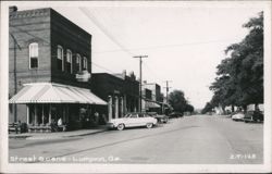 Street Scene with Rexall Drugs, Parked Cars, and People Postcard