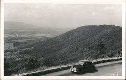 Car on Scenic Mountain Road Overlooking Valley and River Postcard