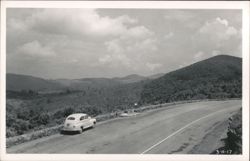 Mountain Road with Vintage Car and Forested Landscape Postcard