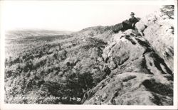 Man on Rocky Face Mountain overlooking forested valley Postcard