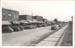 Main Street Scene with Vintage Cars and Businesses Postcard