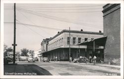 Milton, FL Street Scene with Drug Store, Cleaners, Western Union, and Cars Postcard