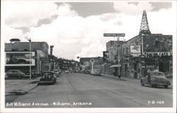 Bill Williams Avenue Street Scene with Businesses and Vintage Cars Postcard