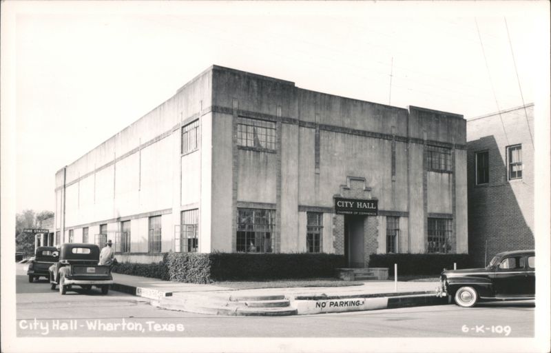 City Hall and Chamber of Commerce building with parked cars Wharton Texas