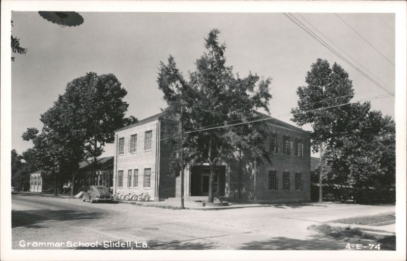Grammar School building with trees and parked car on street Slidell Louisiana