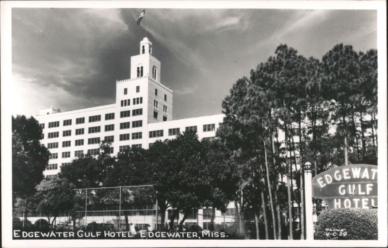 Edgewater Gulf Hotel with prominent tower, flag, and surrounding trees Mississippi