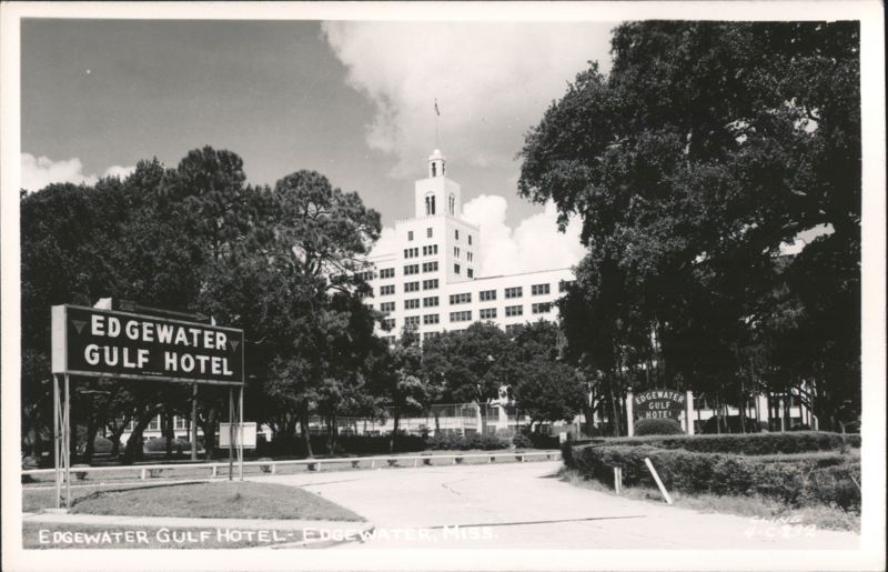 Edgewater Gulf Hotel with Road Sign and Lush Trees Mississippi