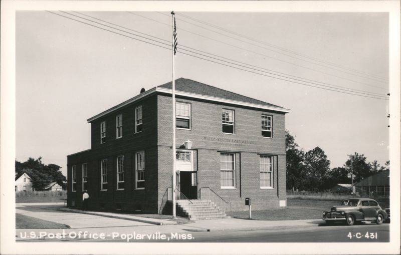 U.S. Post Office building with flag pole and car Poplarville Mississippi