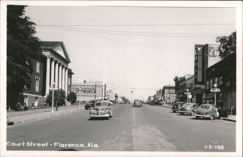 Court Street with classic cars and storefronts in Florence, AL Alabama