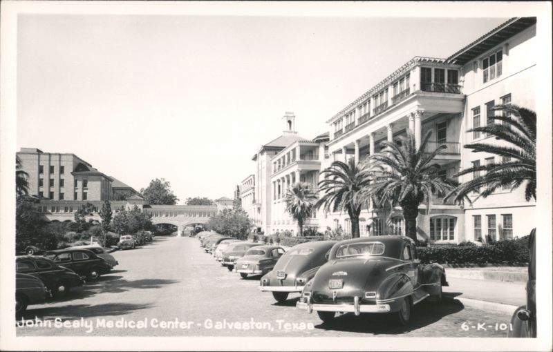 John Sealy Medical Center with Parked Cars and Palm Trees Galveston Texas