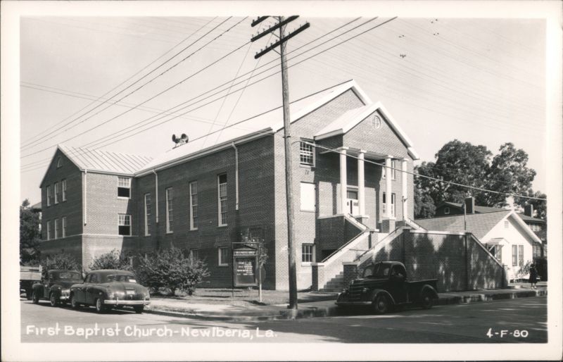 First Baptist Church building with cars parked on street New Iberia Louisiana