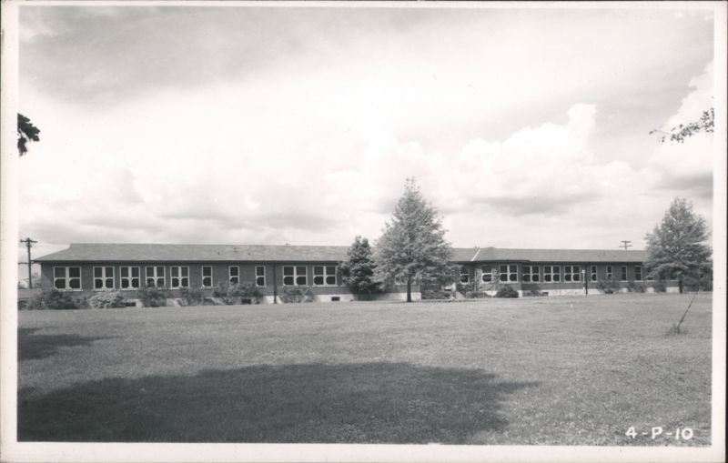 Long single-story building with large lawn and trees Fort Custer Michigan