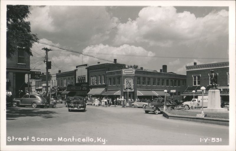 Street Scene with businesses, cars, and statue Monticello Kentucky