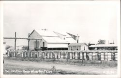 Cotton Gin with Bales of Cotton Stacked in Rows Postcard