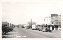 El Campo, TX Street Scene: B.P.O.E. Lodge #1749, vintage cars, and storefronts Postcard