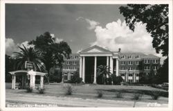 Biloxi Hotel - Grand Facade with Columns and Palm Trees Postcard