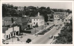 Main Street, Guntersville, Alabama with cars and buildings Postcard