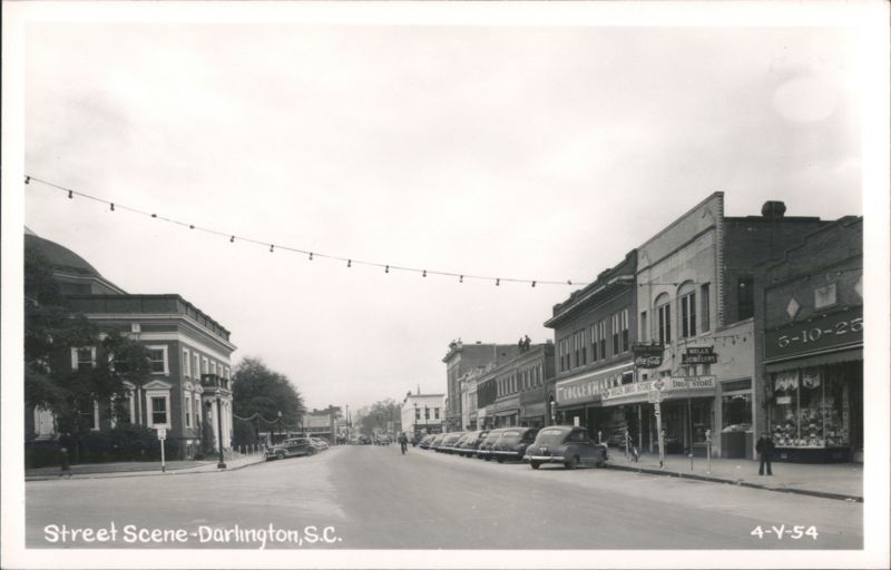 Street Scene with Dome Building, Businesses, Cars, and String Lights Darlington South Carolina