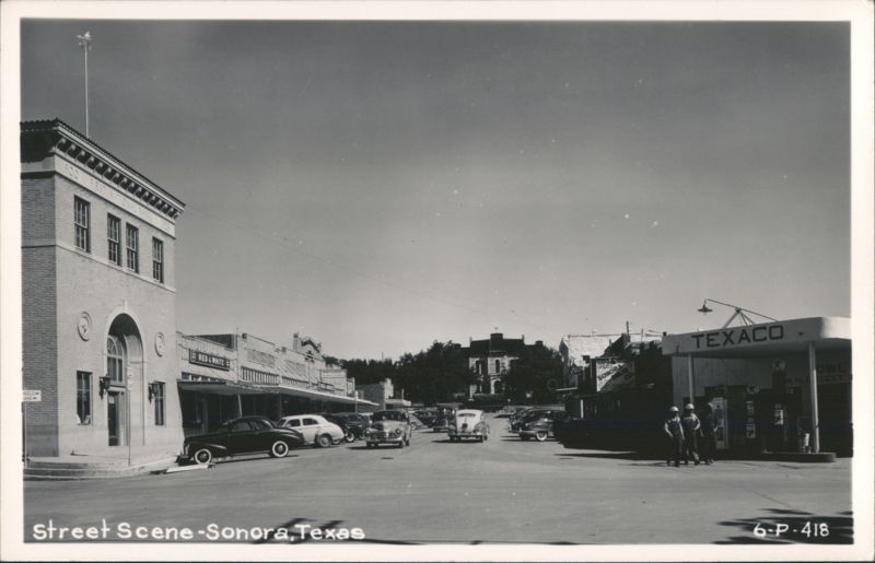 Street Scene with Texaco Gas Station, First National Bank, and Vintage Cars Sonora Texas