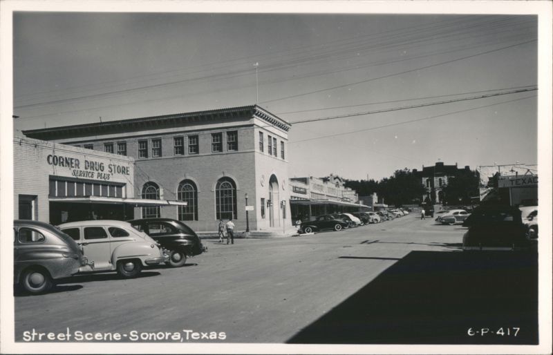 Street Scene with Corner Drug Store and Texaco Station Sonora Texas