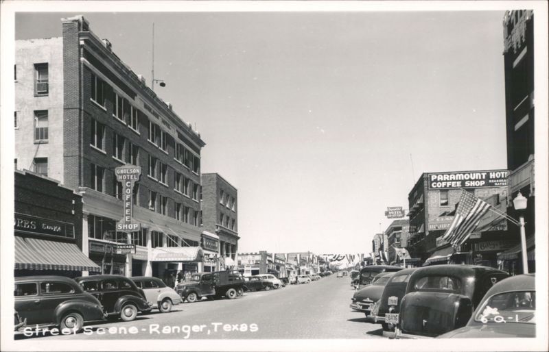 Street scene with Gholson Hotel, Paramount Hotel, and parked cars Ranger Texas